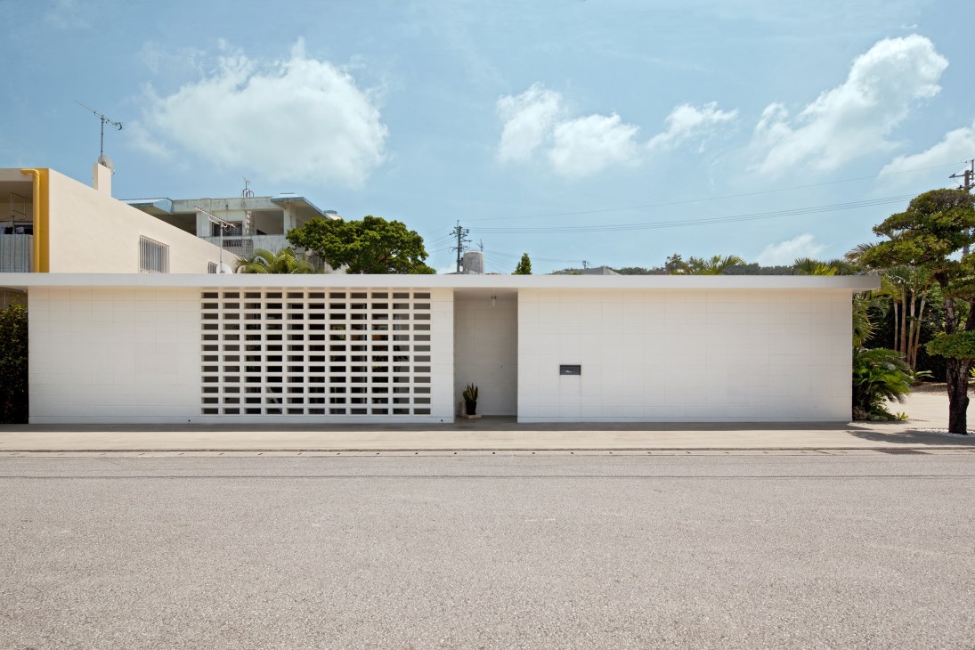 White concrete single-storey Okinawa Standard house with hollow hana blocks and clean modernist design.