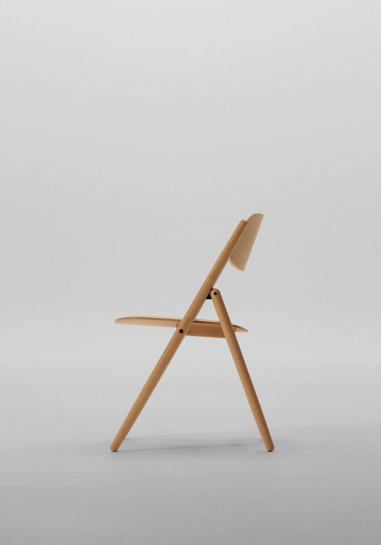 Beech folding chair with angled backrest and seat by Maruni Wood Industry's Hiroshima series.