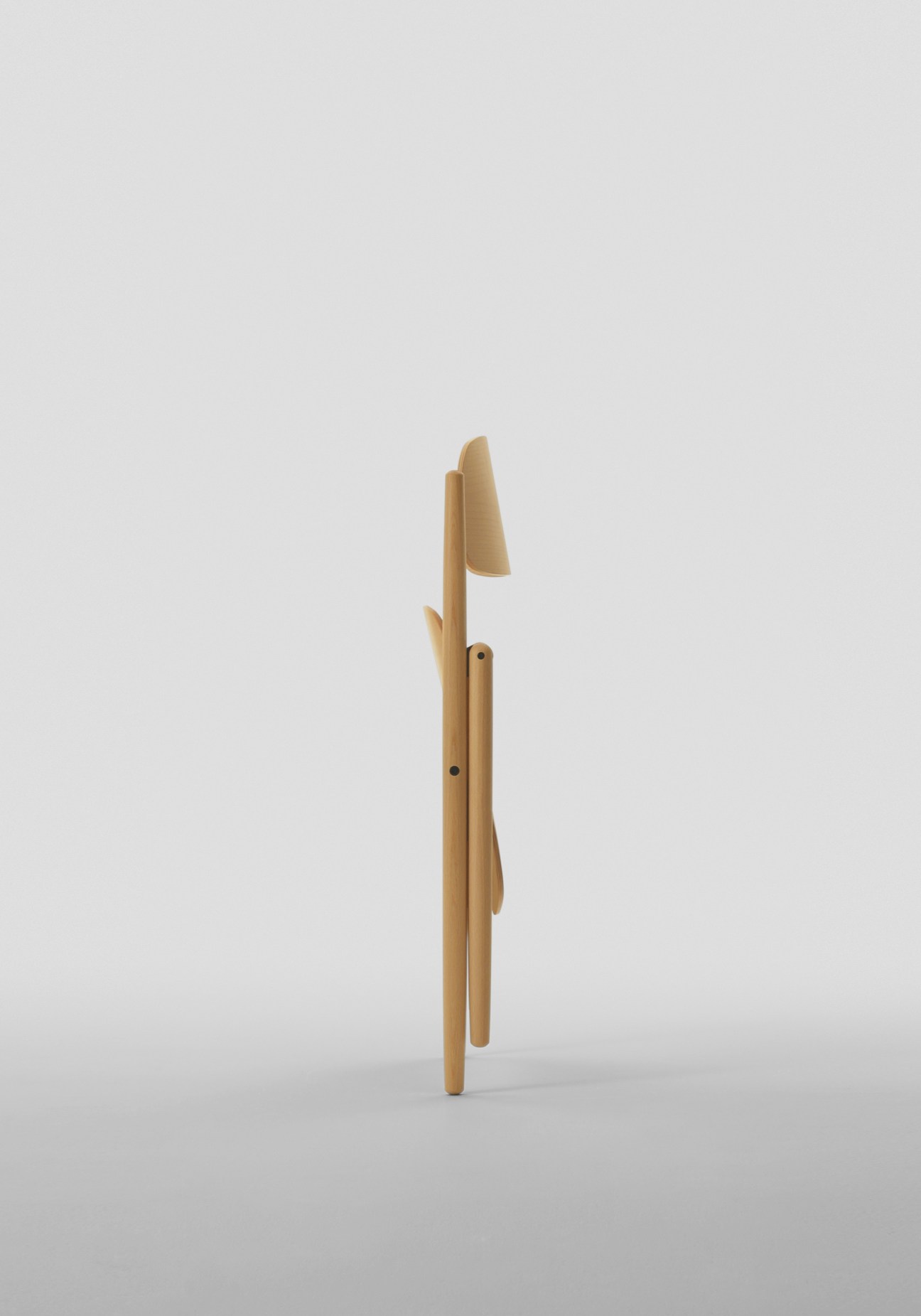 Wooden folding chair by Maruni Wood Industry, designed by Naoto Fukasawa, shown from the side.
