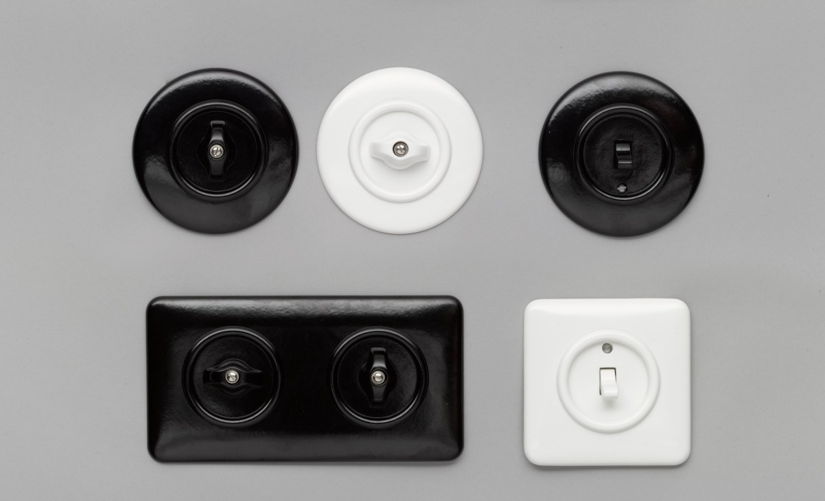 Collection of traditional rotary, rocker and toggle light switches in black and white finishes made from Bakelite and porcelain.