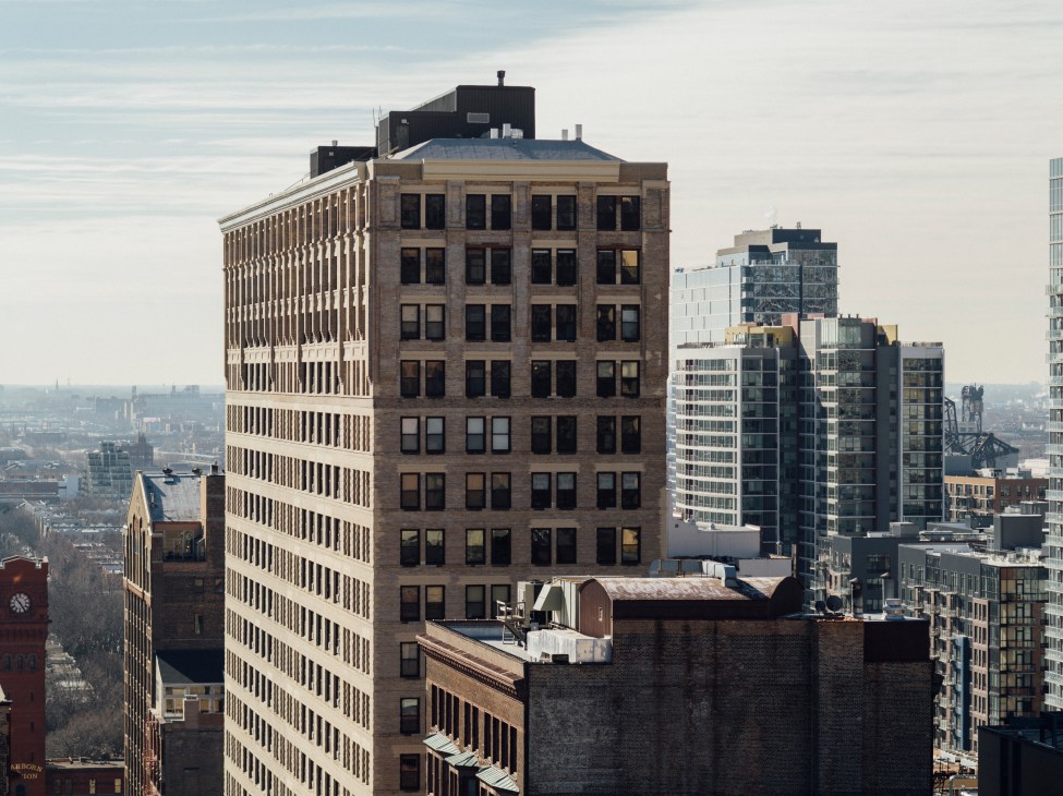 Chicago skyline view from rooftop showing mix of historic brick and modern glass buildings