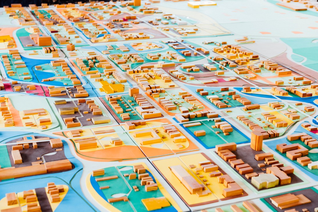 Detailed architectural model of Chicago's Washington Park neighbourhood with wooden building blocks on a colored map.