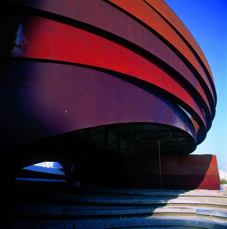 Red and blue curved modern architecture of Holon's design museum in Israel.