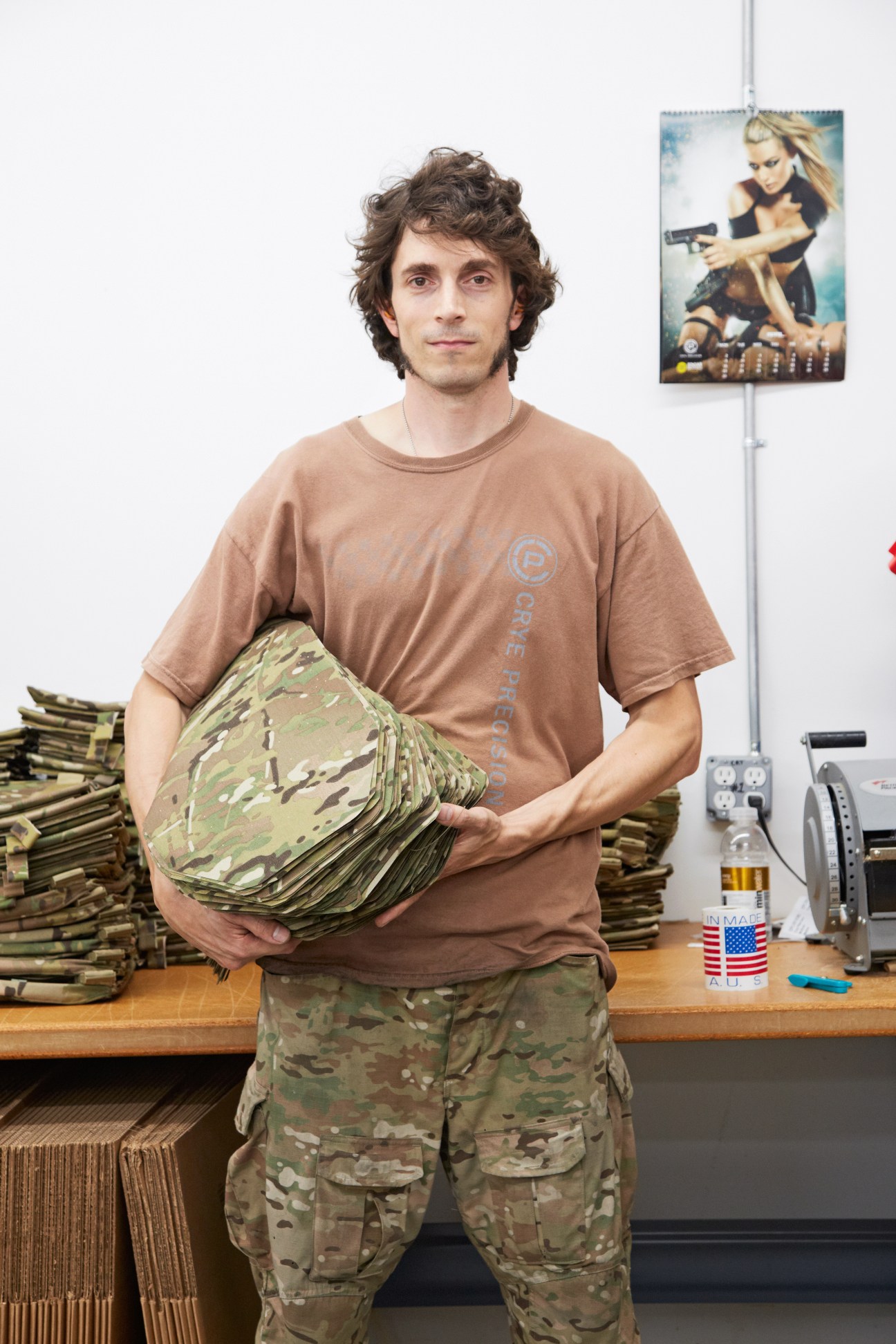 Mat Heyner, head of automated cutting at Crye Precision, holds a stack of MultiCam fabric in his office.