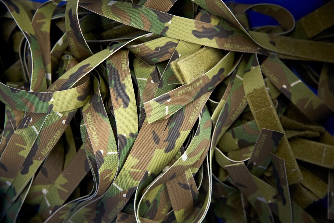 Coiled MultiCam camouflage pattern straps in green, tan, and brown tones with white stitching.