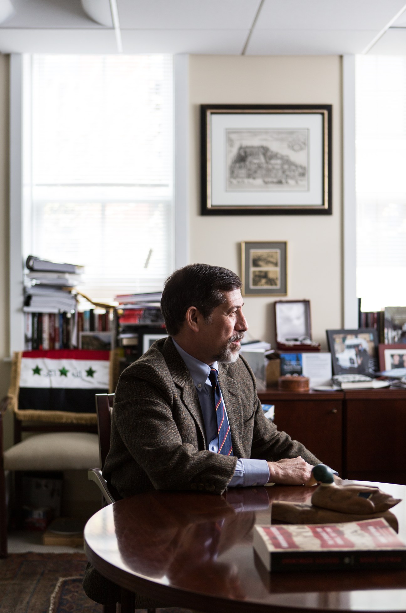 Bruce Hoffman, terrorism expert, sits at his desk in his office surrounded by memorabilia from international travels.