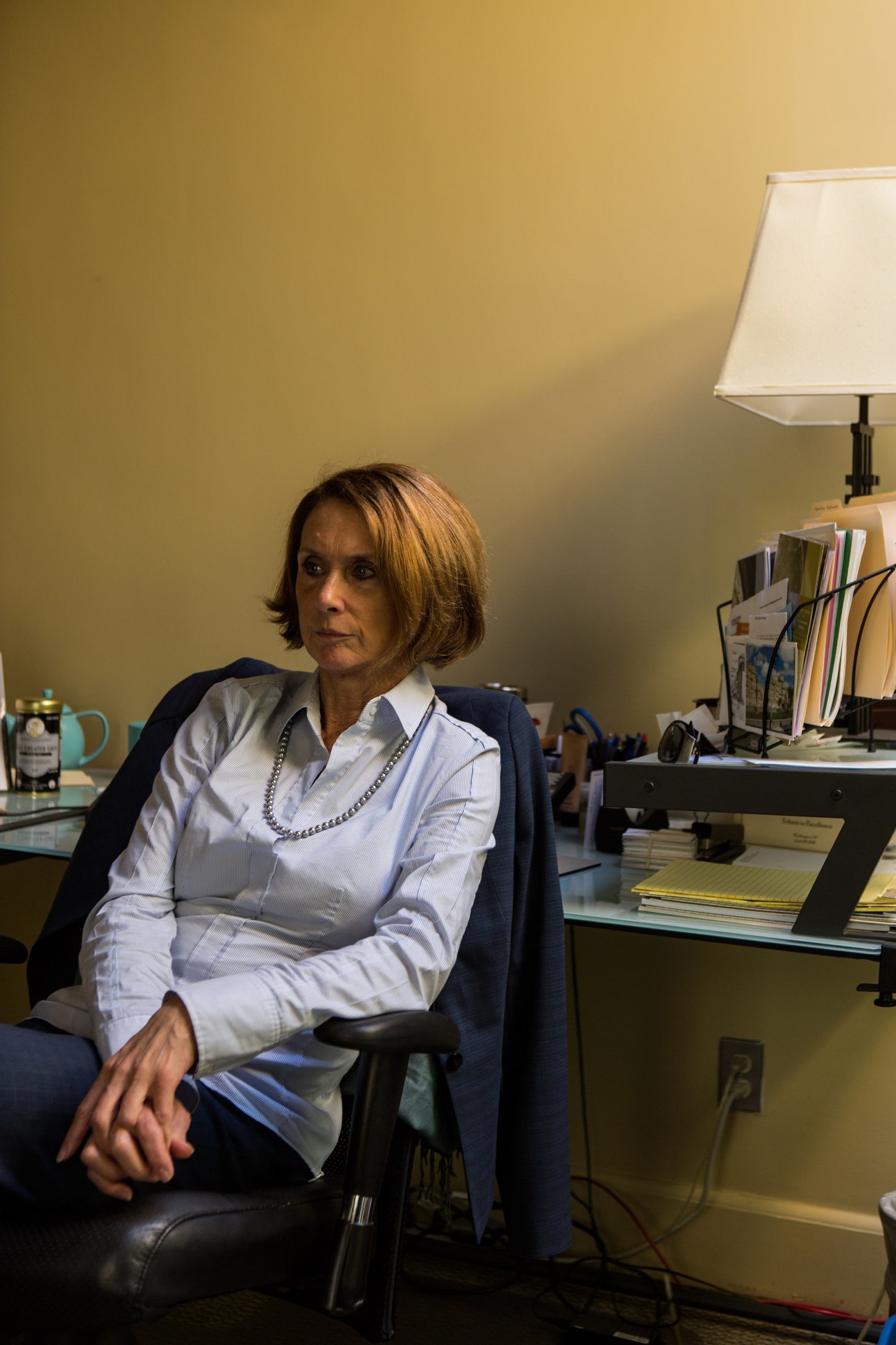 Barbara Bodine, former ambassador to Yemen, seated in her office wearing a blue blazer and pearl necklace.