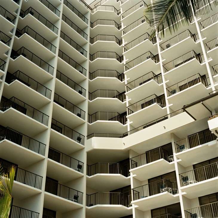 The Halekulani hotel's white modernist facade with repeating balconies and geometric curves.
