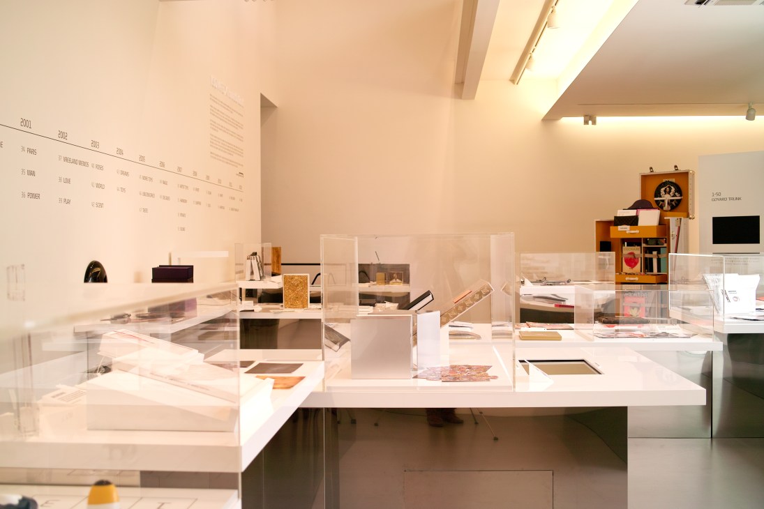 Display cases of design artefacts and objects in the minimalist exhibition space of the Hyundai Card Design Library.