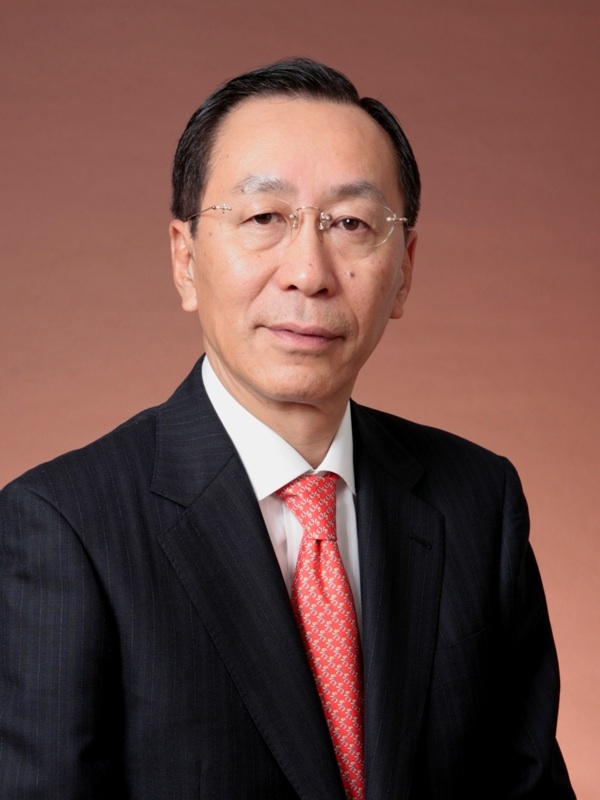 Portrait of Moriyuki Ohnishi, vice-president of Torayca Division at Toray Industries, wearing glasses and a dark suit with red tie.