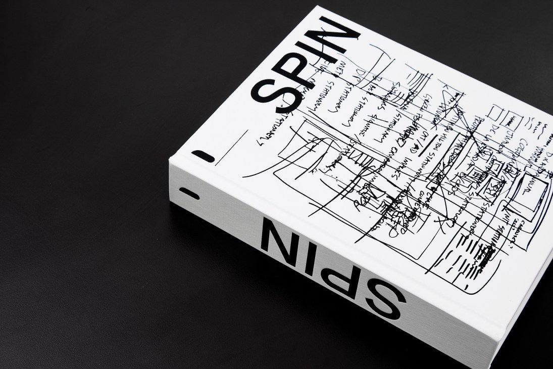 Spin Adventures in Typography book displayed at an angle showing typographic design sketches and annotations on its cover.