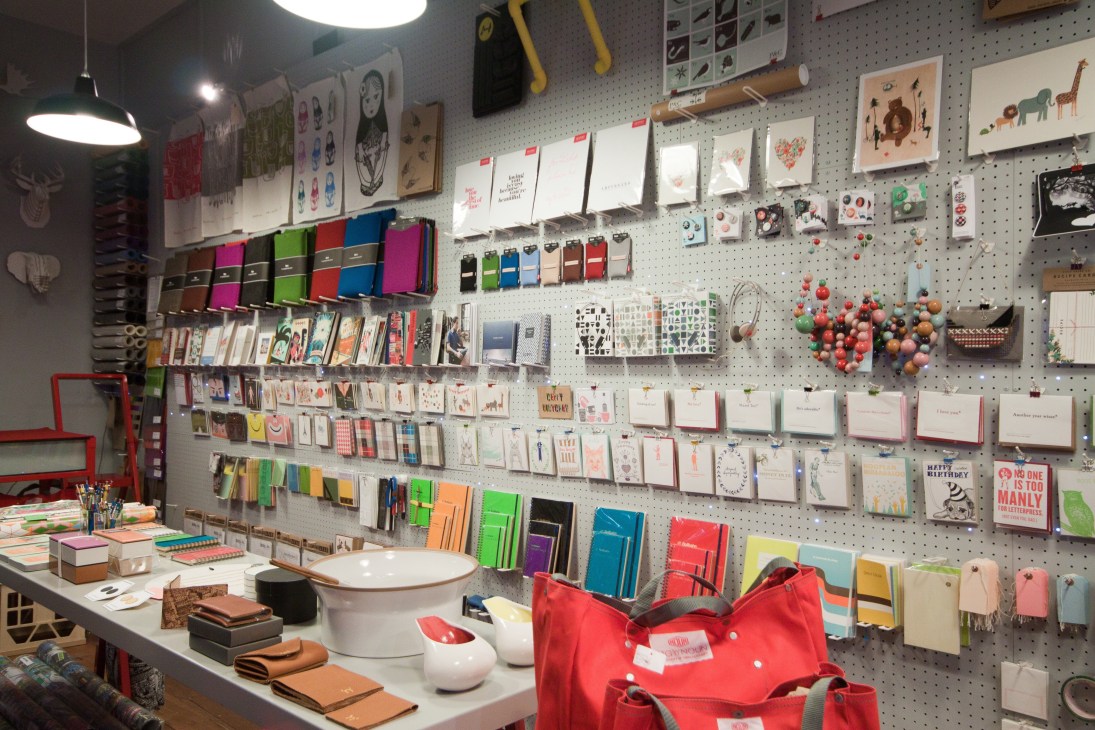 B&M store display wall with colorful notebooks, stationery, and handmade baker's twine products.
