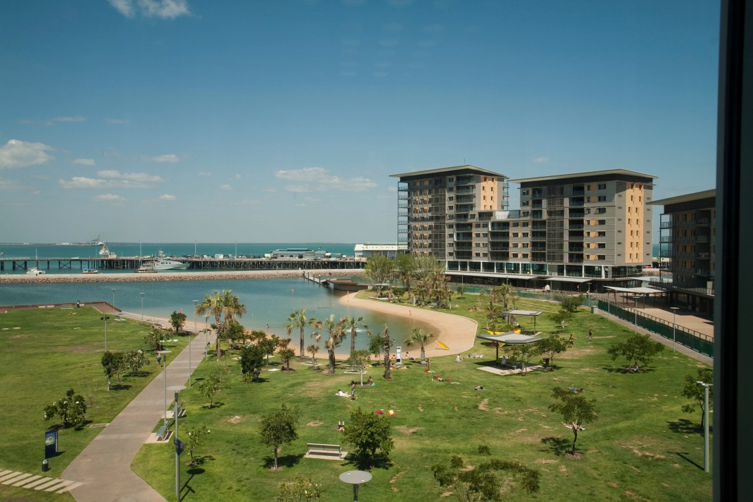 Modern waterfront residential towers with beach and wave pool at Darwin's wharf development.