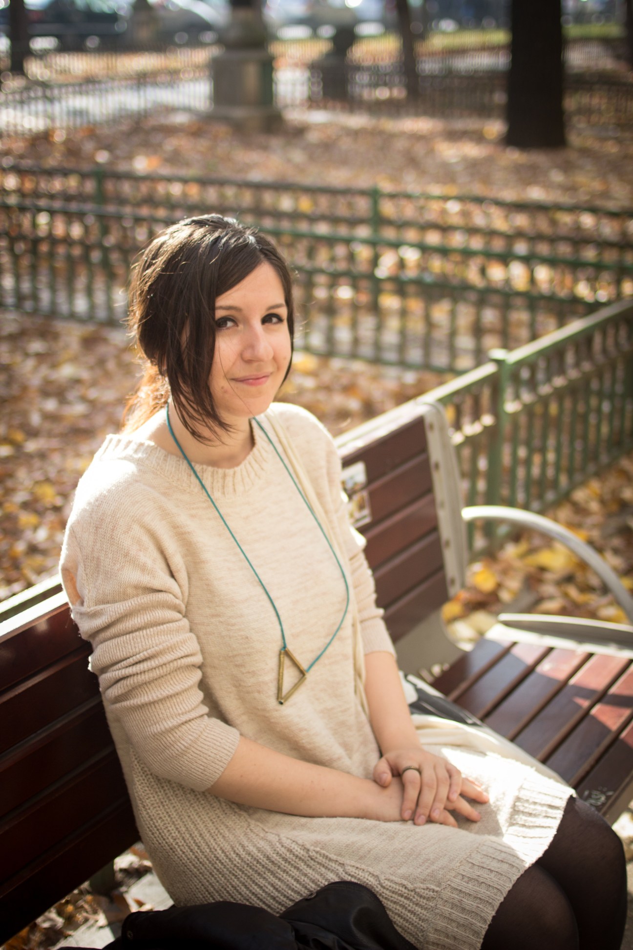 Ioana Sopov, a 25-year-old freelance illustrator, sits on a bench in Cismigiu Gardens, Bucharest.