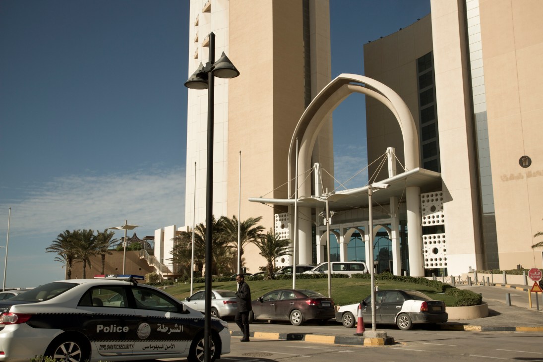 Police vehicle parked outside the InterContinental hotel in Kabul with armed officers visible