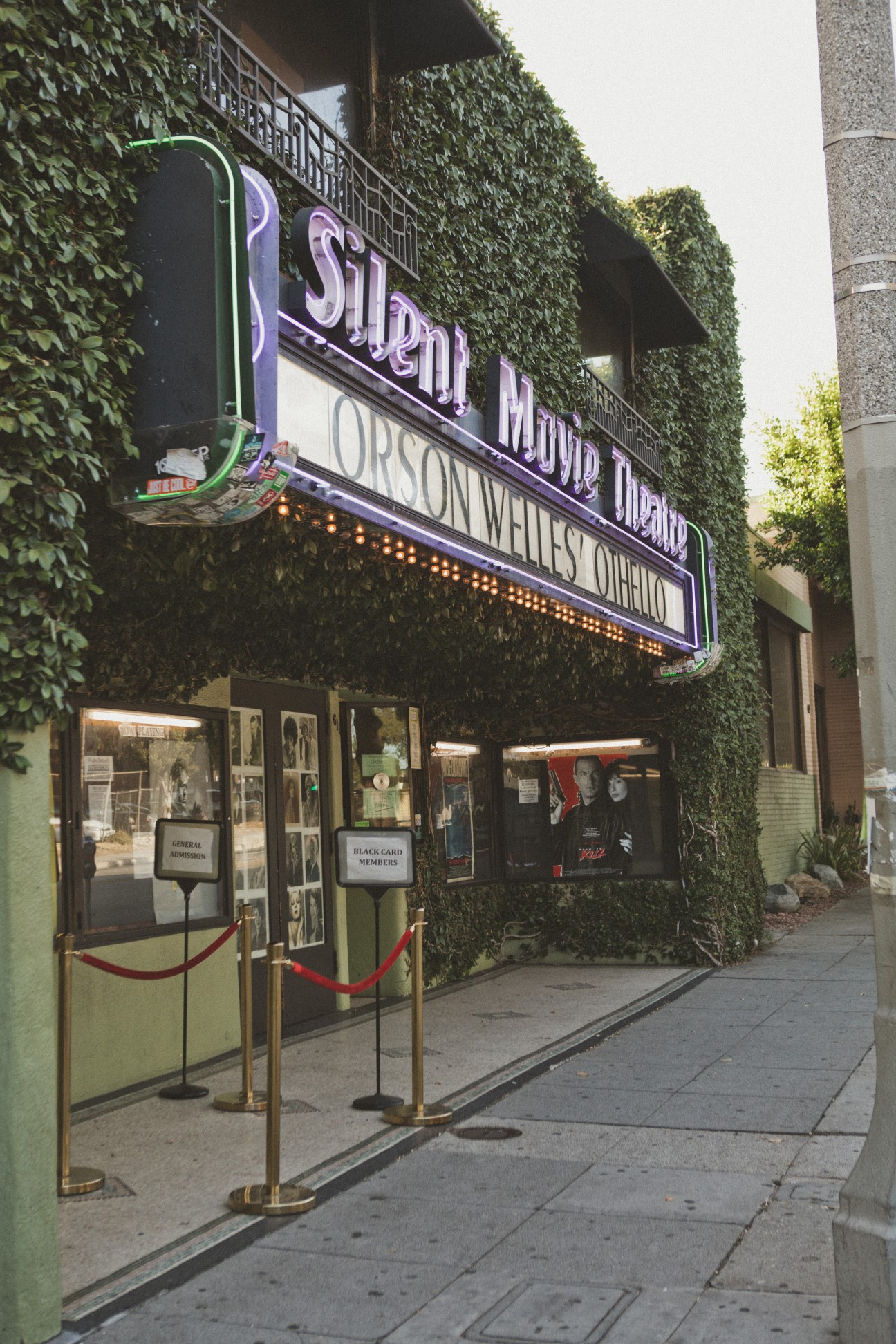 Cinefamily's ivy-covered exterior with neon "Silent Movie Theatre" signage and entrance doors.