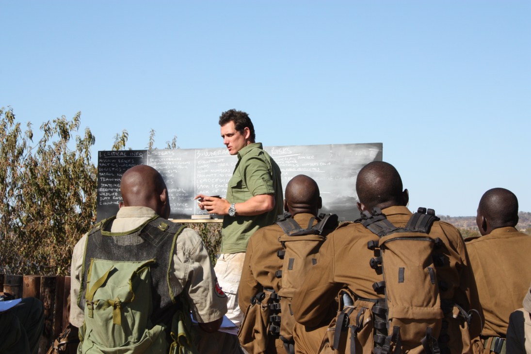 Damien Mander, an Australian Special Operations sniper, instructs anti-poaching rangers during outdoor training in Zimbabwe.
