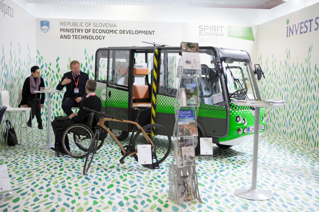 Slovenia's Ministry of Economic Development and Technology exhibits a green and black bus with wheelchair accessibility at Mipim property fair.