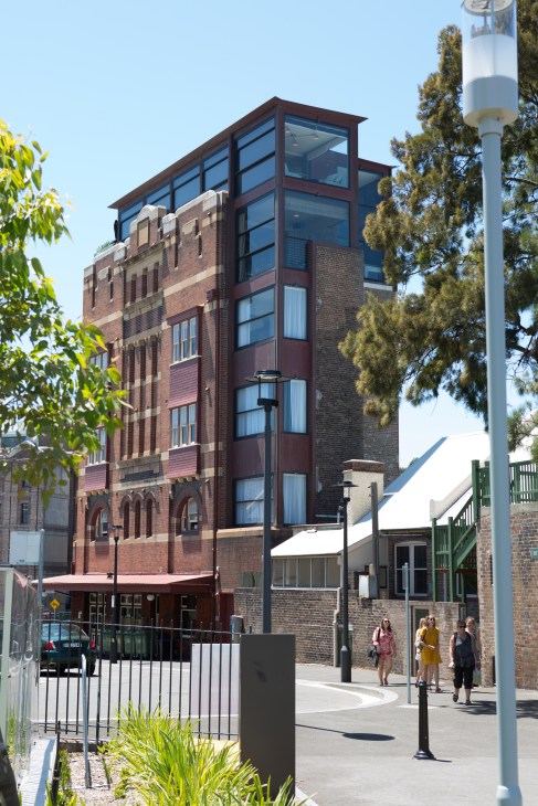 Hotel Palisade exterior, a renovated brick building with modern glass addition, viewed from Millers Point in Sydney.