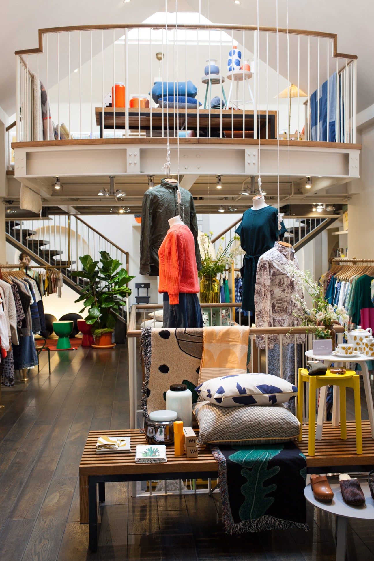 Interior of Couverture and the Garbstore retail store in London showing two-level loft space with clothing displays and homeware.