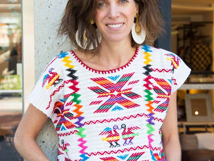 Lago owner Regina Barrios wearing a colorful traditional Mexican patterned top