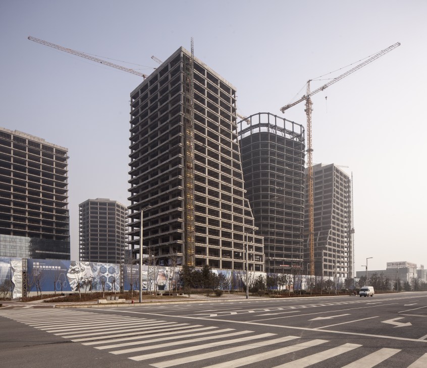 Construction site with multiple high-rise buildings under development and cranes in Xi'an's International Trade and Logistics Park