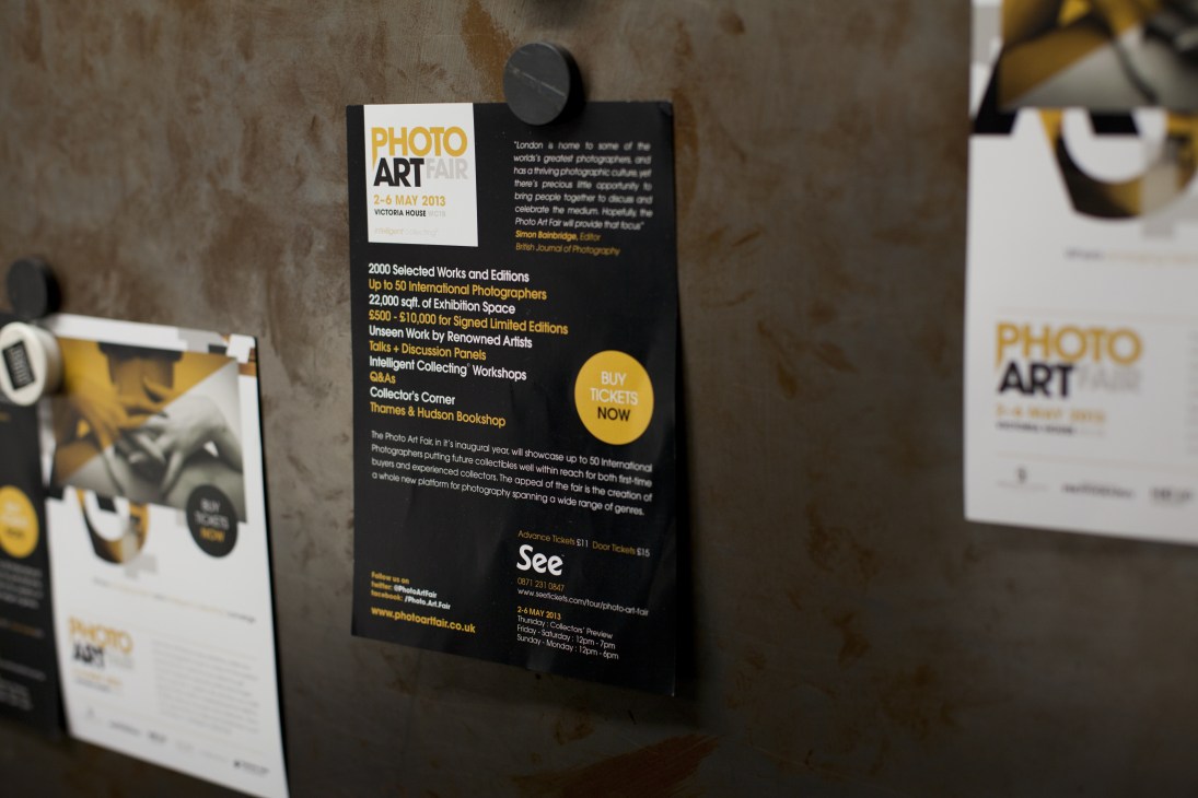 Photo Art Fair promotional posters displayed on a concrete wall.