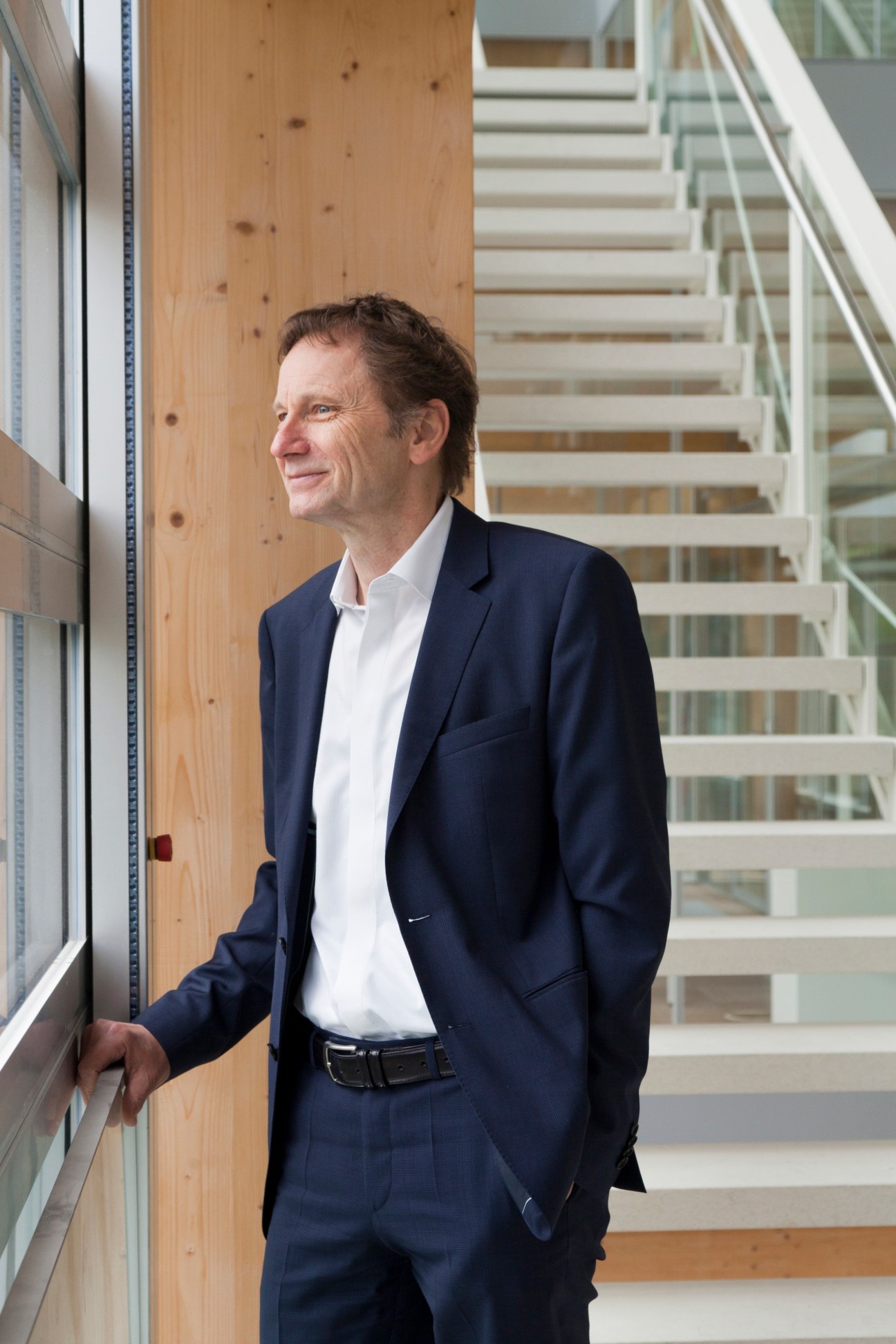 Res Strehle, editor-in-chief of Tages-Anzeiger, stands in the wooden timber interior of Tamedia's new office building.