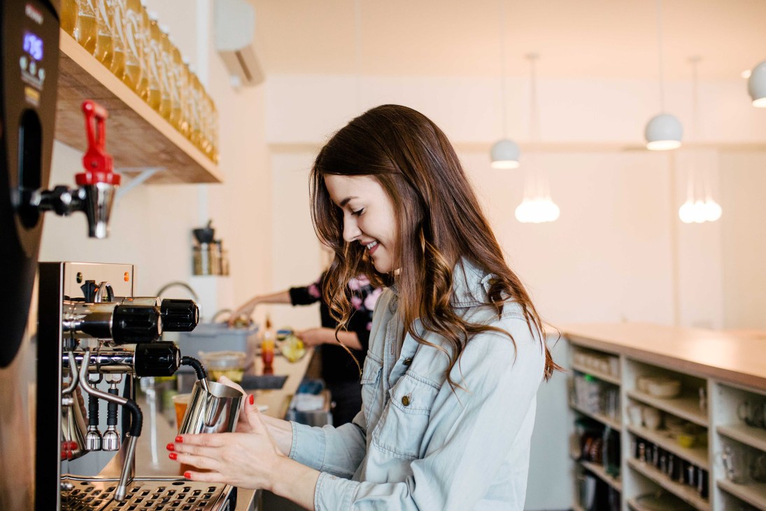Woman smiling while pouring tea at Tea Bar in Portland, Oregon