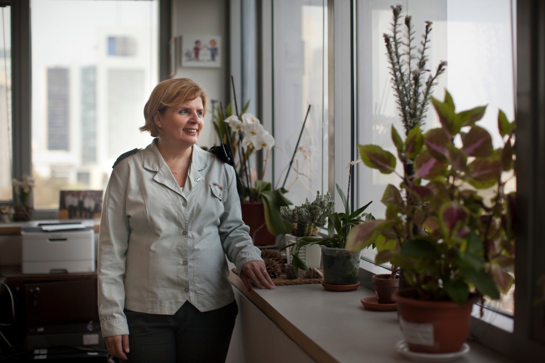 Major General Orna Barbivai stands by a window in an office with potted plants, wearing a light-colored military uniform.