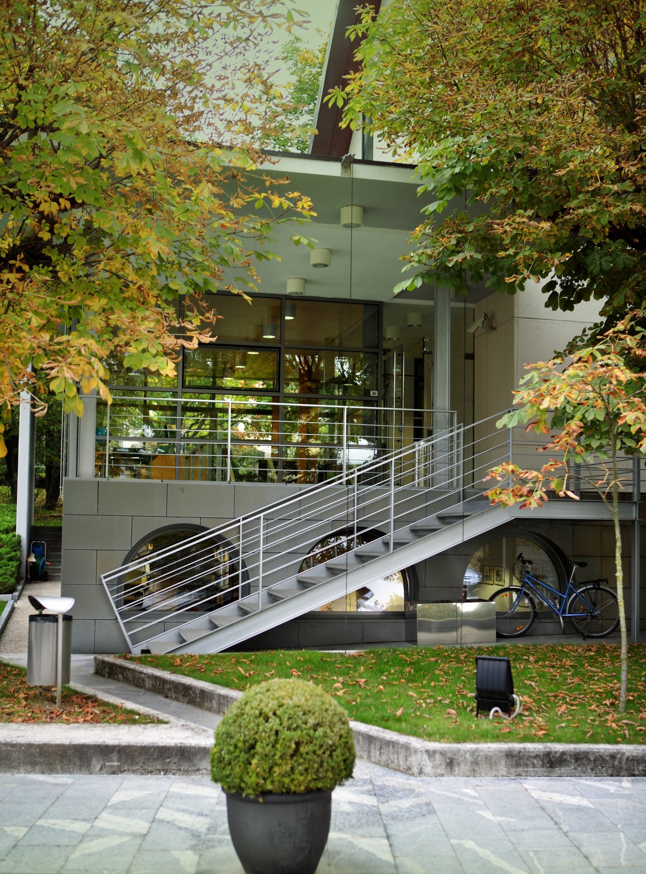 Modern building with metal staircase surrounded by autumn foliage at Bled School of Management