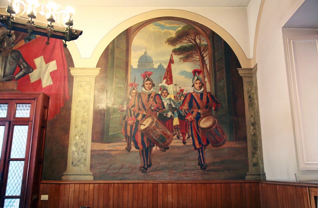 Mural painting of Swiss Guards in historical uniforms with drums in Vatican dining room