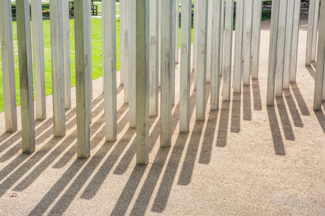 Rows of stainless steel stelae cast in shadow at Carmody Groarke's 7/7 memorial in Hyde Park, London.