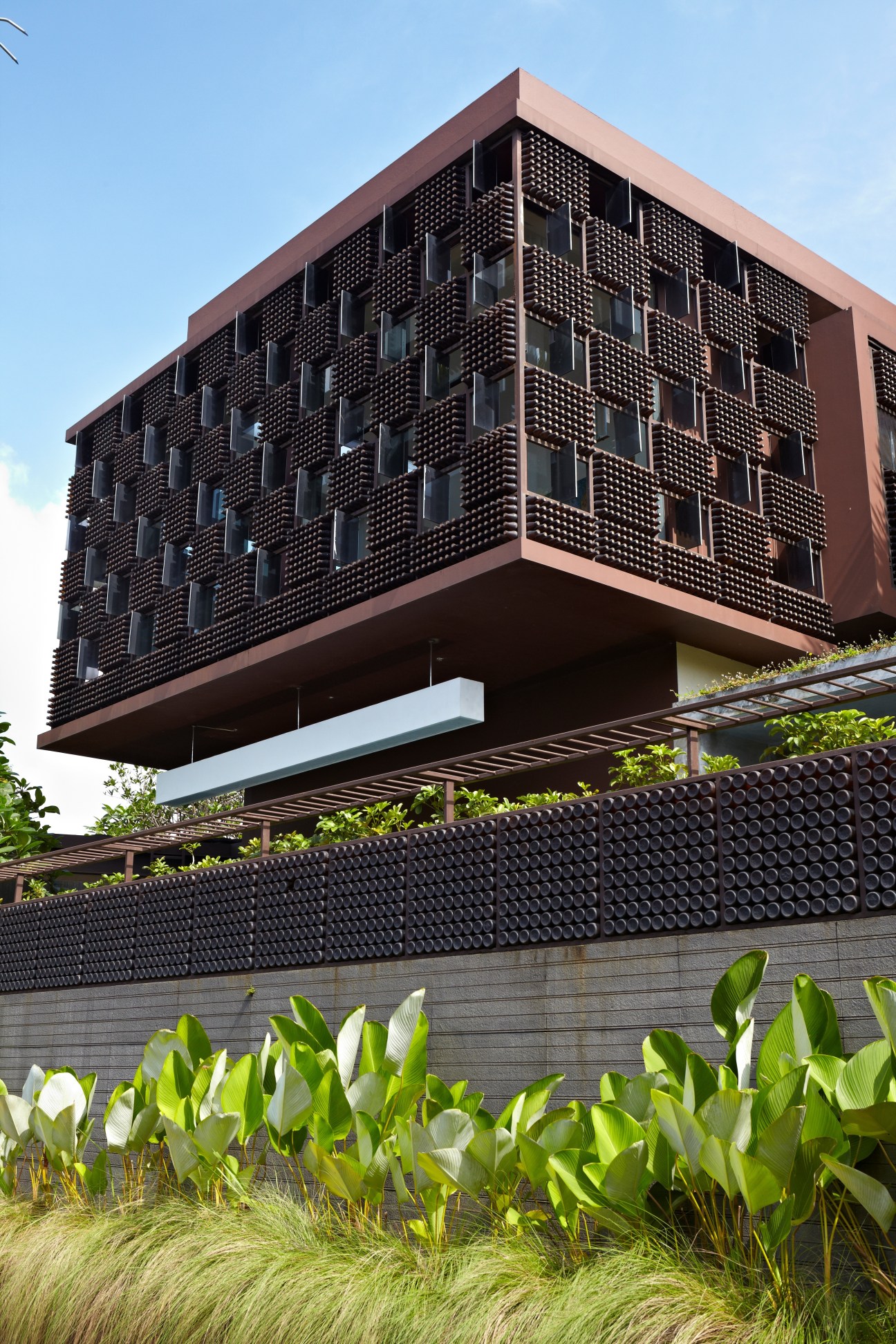 Modern brick building with perforated facade and elevated design by architect Ridwan Kamil.
