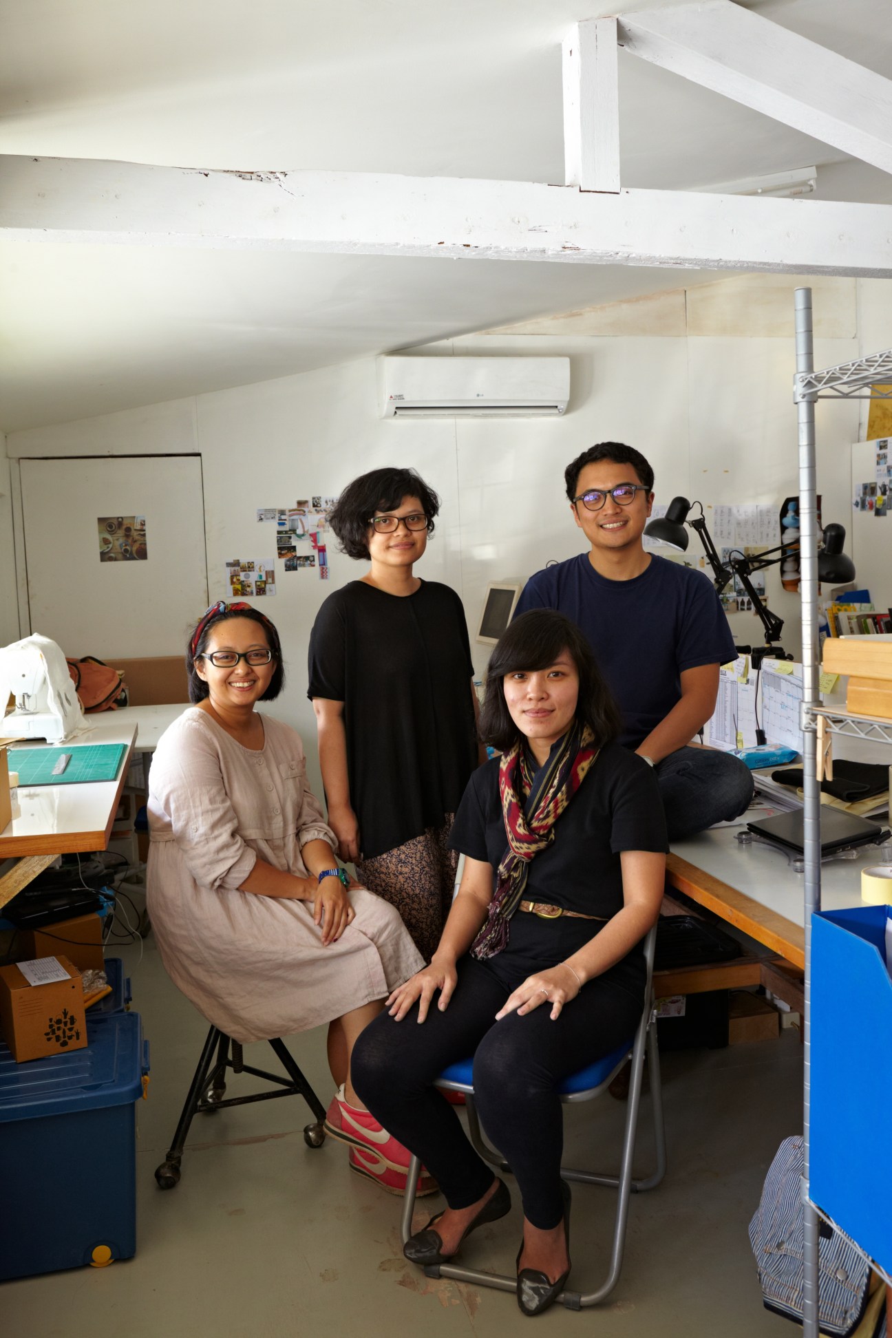Four members of Kandura Ceramic pose in their workshop studio.