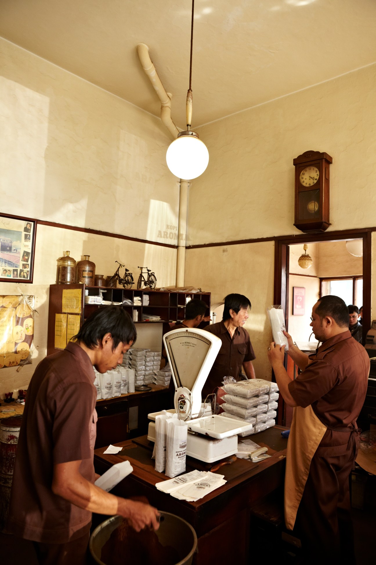 Staff members packing coffee at Kopi Aroma, a family-run coffee roaster in Bandung.