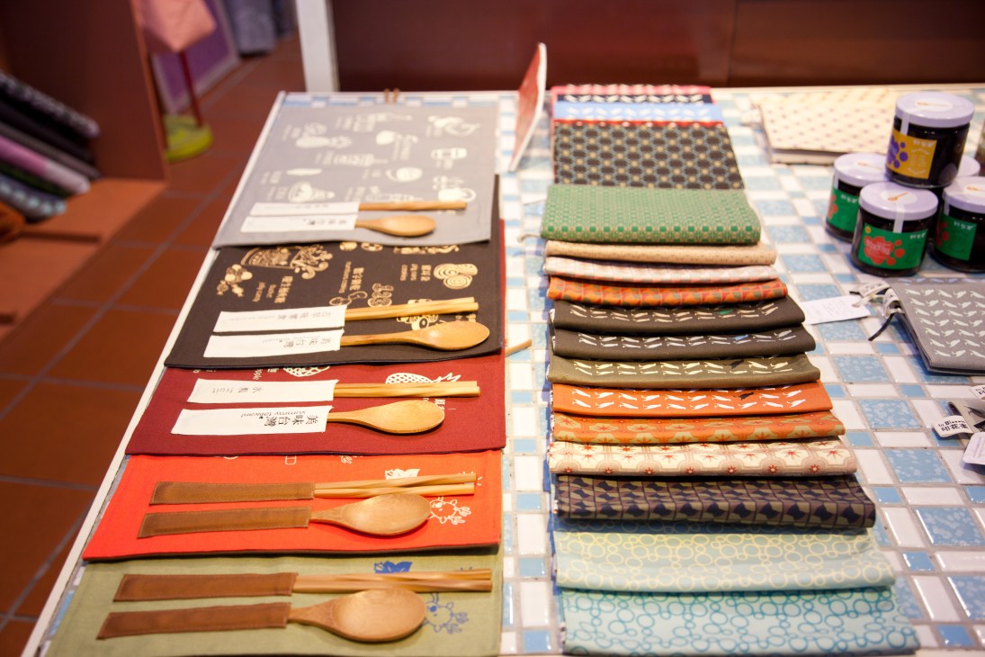 Colorful textile place mats and wooden utensils displayed on a table at Art Yard.