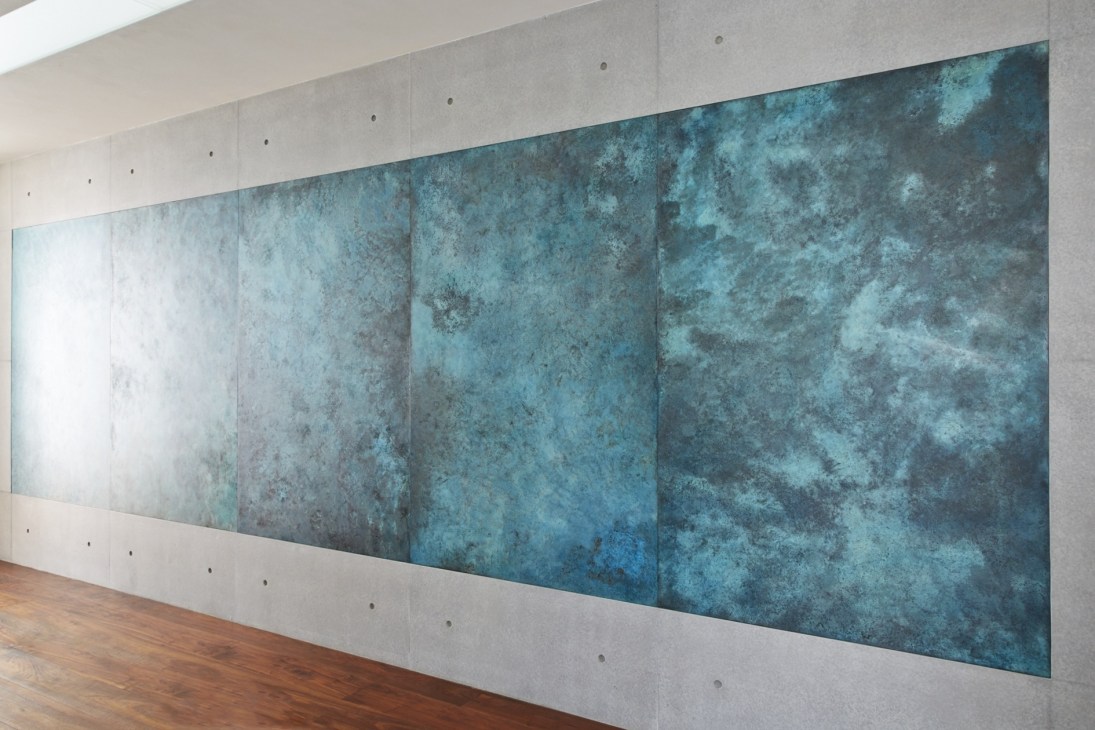 Oxidised copper panels installed along a wall in Indigo House, Tokyo by Hiroshi Seki.