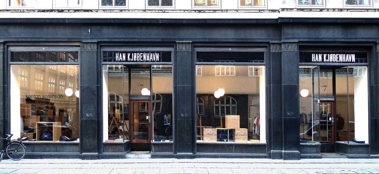 Han Kjøbenhavn flagship store storefront in Copenhagen with large windows and signage.