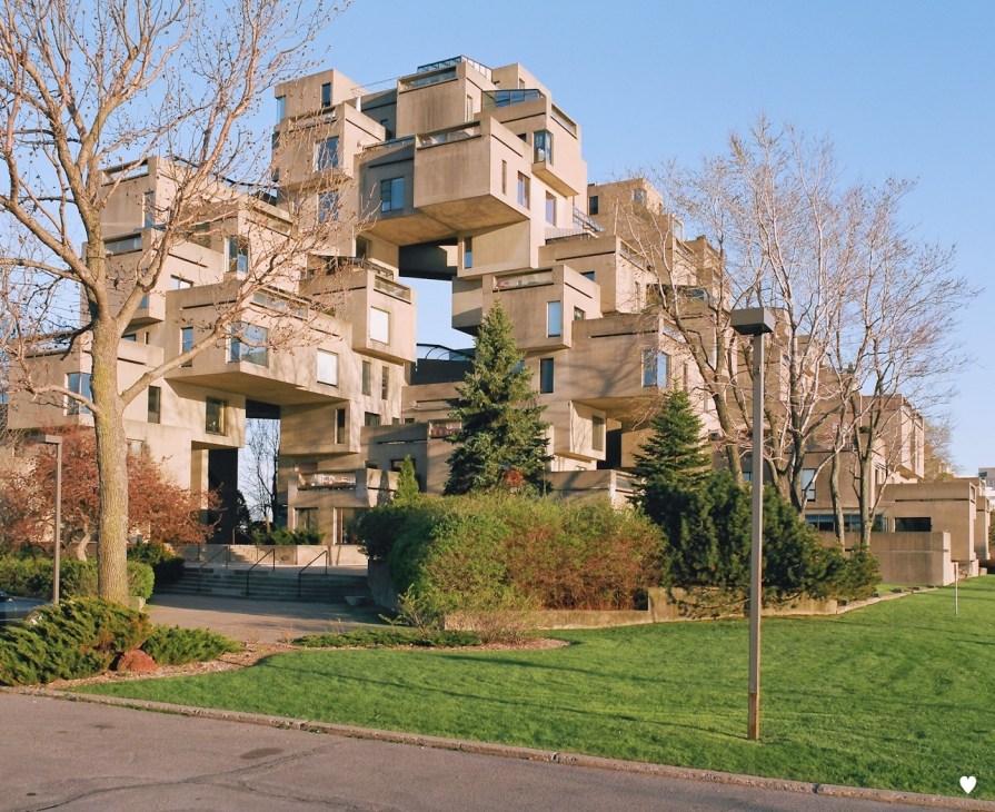 Habitat 67's distinctive stacked concrete cube residential complex with protruding balconies among bare trees.