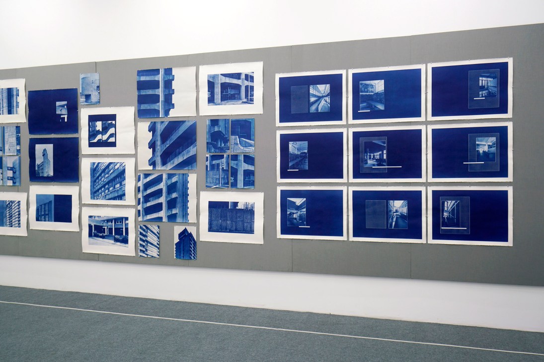 Gallery wall displaying cyanotype prints by Seher Shah and Randhir Singh featuring modernist architecture in vivid blue tones.