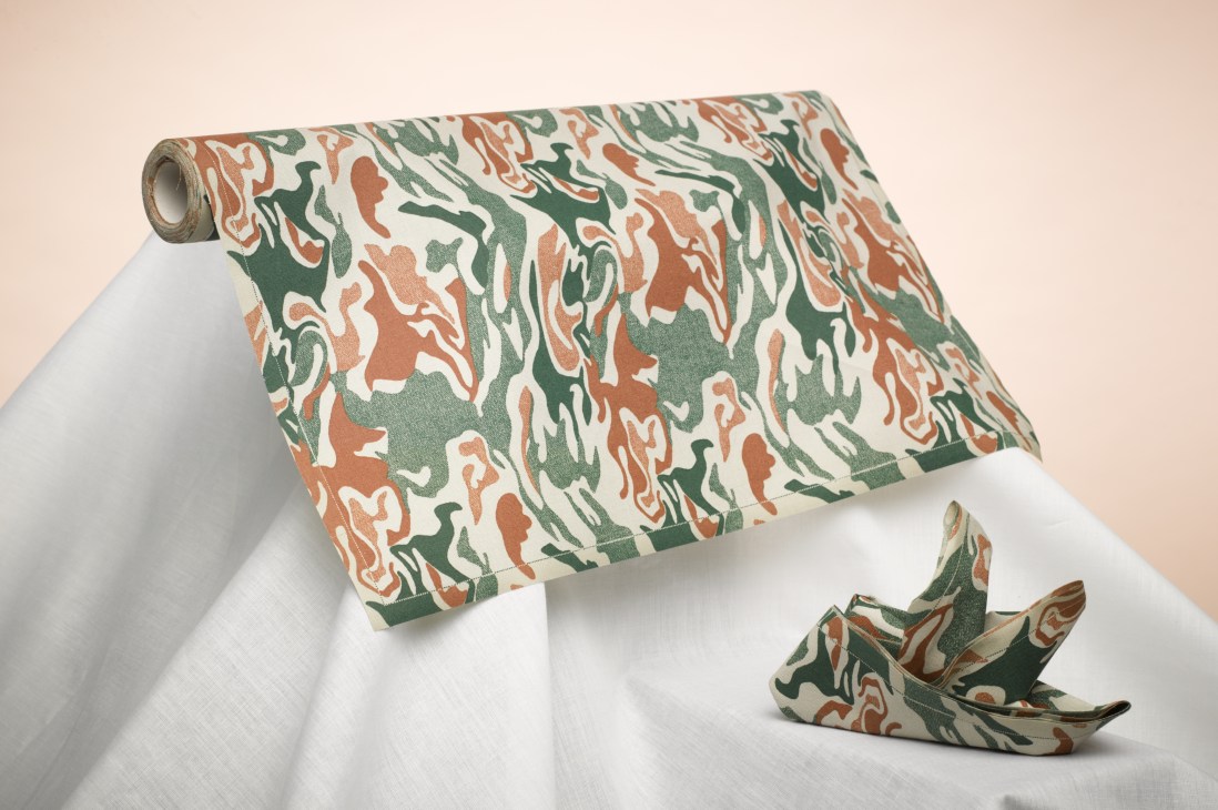 Rolled camouflage patterned water-resistant cotton napkins by MYdrap with origami bird fold.