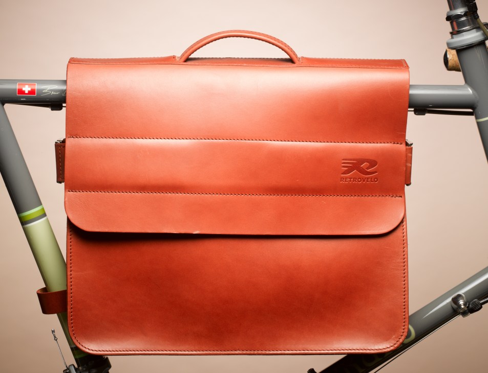 Orange leather Retrovelo bike bag mounted on a Bruno mini-velo bicycle frame.