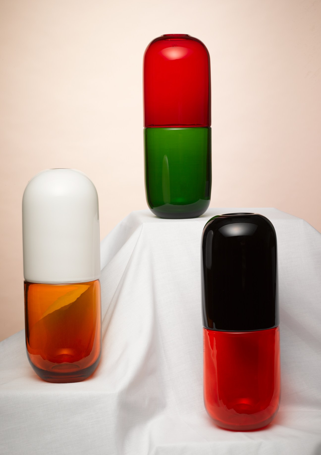 Three colorful Murano glass vases shaped like capsules in red, orange and green by Venini designer Fabio Novembre.