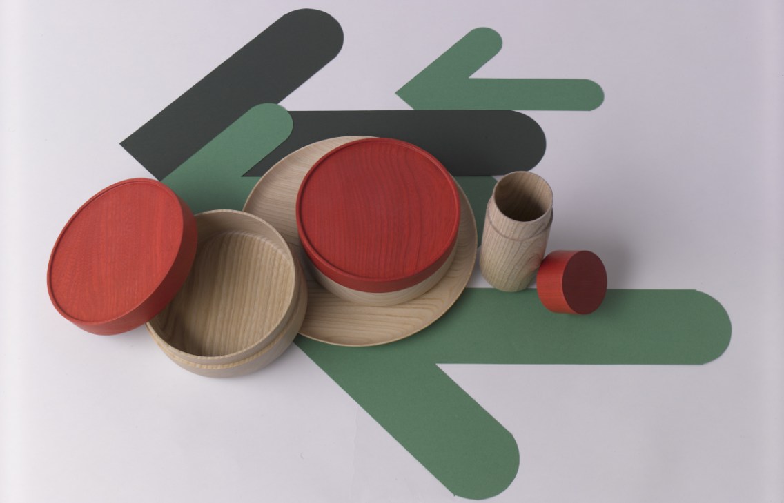 Mute wooden lacquerware including plates, bowls and storage canisters in natural wood and red finishes.