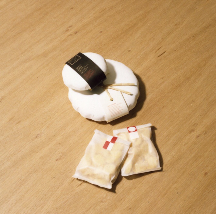 Zen Castella cakes in white paper packaging with red labels on wooden surface.