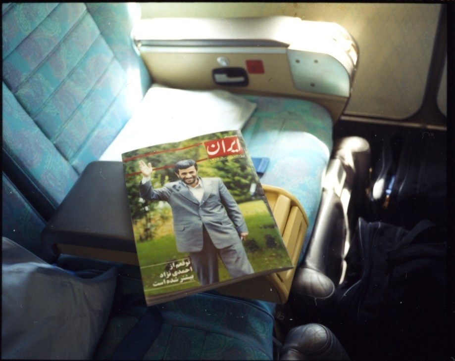 Iranian magazine with Mahmoud Ahmadinejad on cover lying on airplane seat