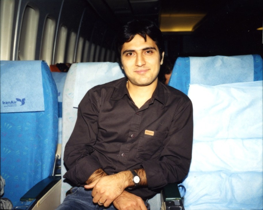 Kayvan, a businessman, seated on IranAir Flight 744 wearing a dark shirt.