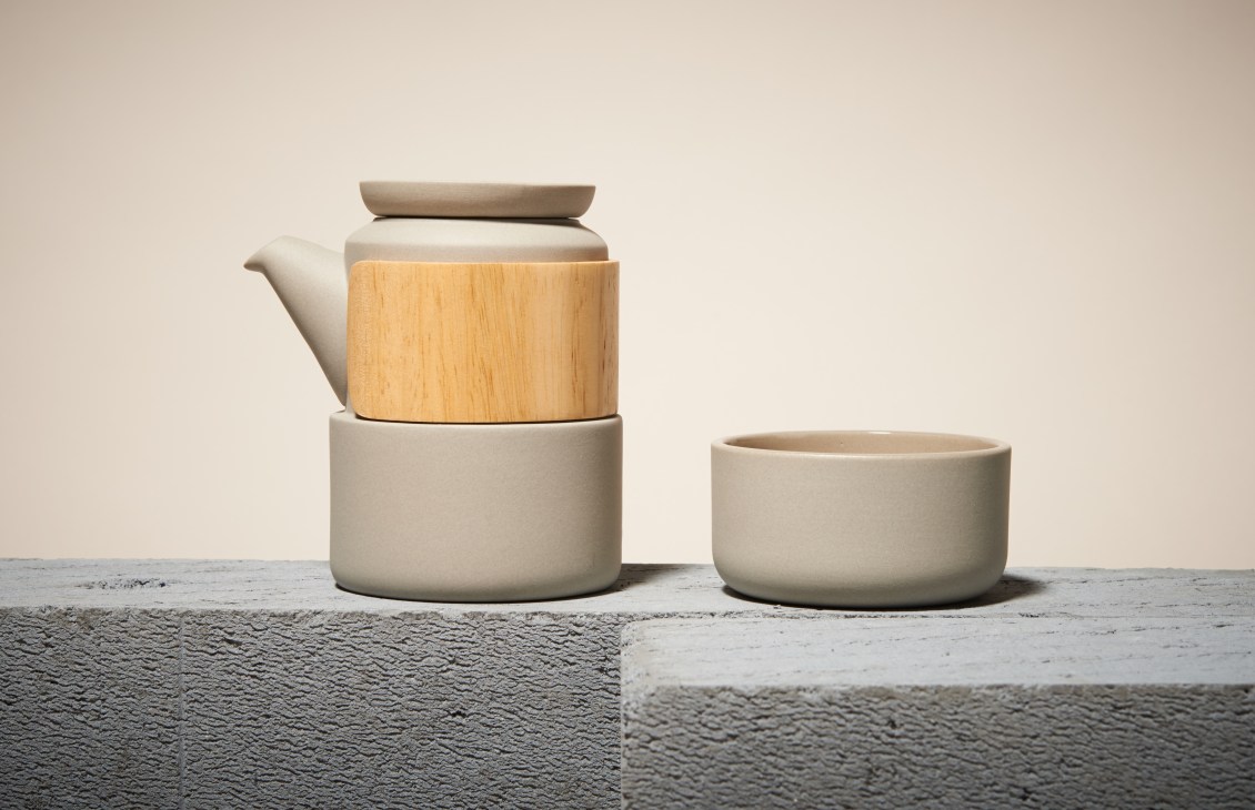 Stone teapot with wooden heat-resistant handle and matching cup by Cuckoo.