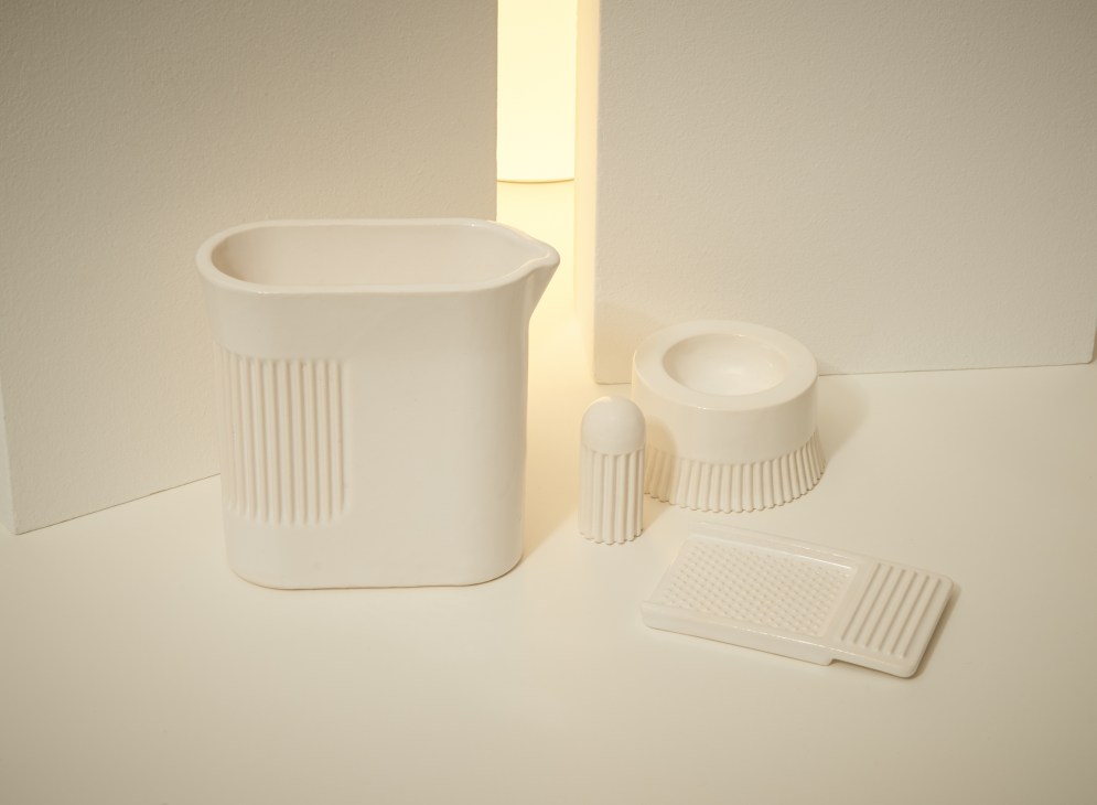White porcelain kitchenware set by Visibility with ridged grip pattern includes pitcher, bowl, and server on neutral background.